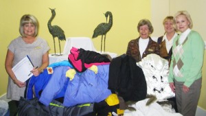 NMB Woman's Club members donate coats to local school children.